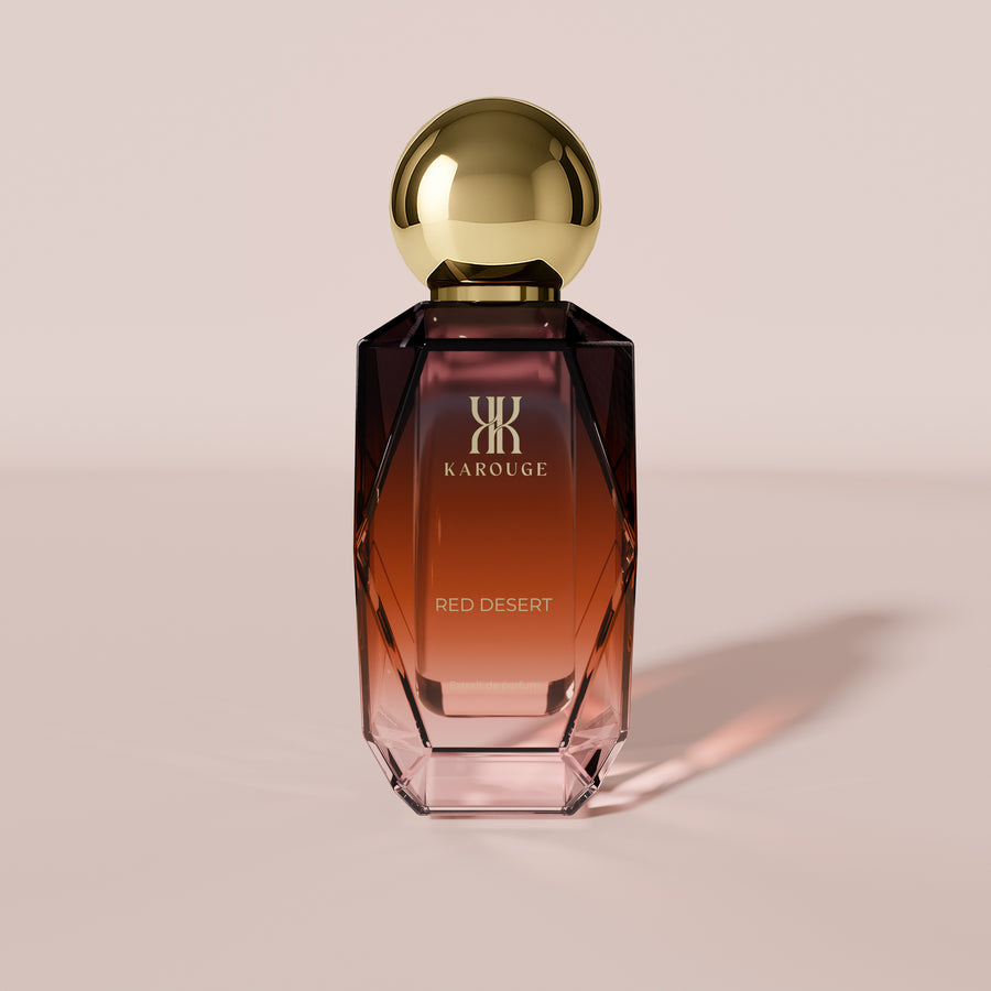 Red Desert Extrait de Parfum 50 ml: Flakon mit goldener Kugelkappe und Farbverlauf von Bordeaux zu Rosé